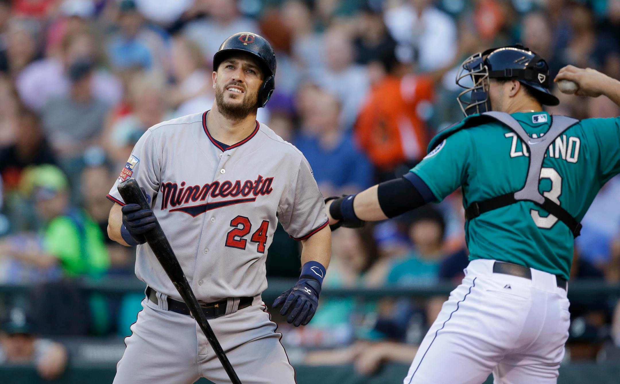The Twins' Trevor Plouffe turned toward the dugout after striking out as Seattle catcher Mike Zunino returns the ball to the mound.