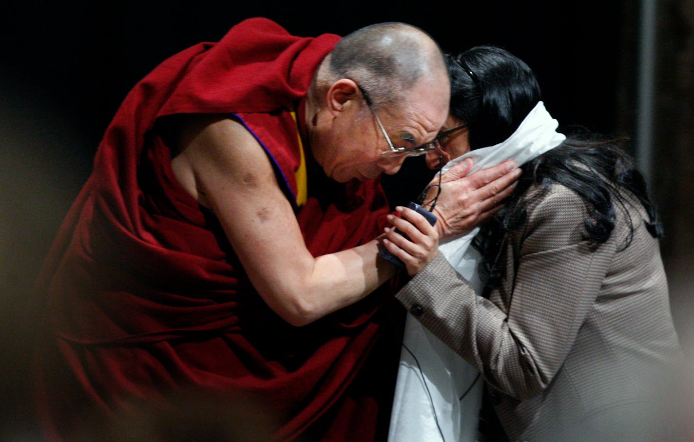 The Dalai Lama offered a scarf as a thank-you gift to Dr. Nisha Manek, who works in integrated medicine at the Mayo Clinic in Rochester. The Tibetan spiritual leader spoke with about 400 of the clinic's doctors and nurses about compassion, mind-body healing and emotional well-being Wednesday.