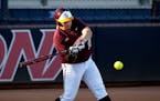 Minnesota's Sara Groenewegen singles in the first inning during an NCAA college softball tournament regional game against New Mexico State, Saturday, 
