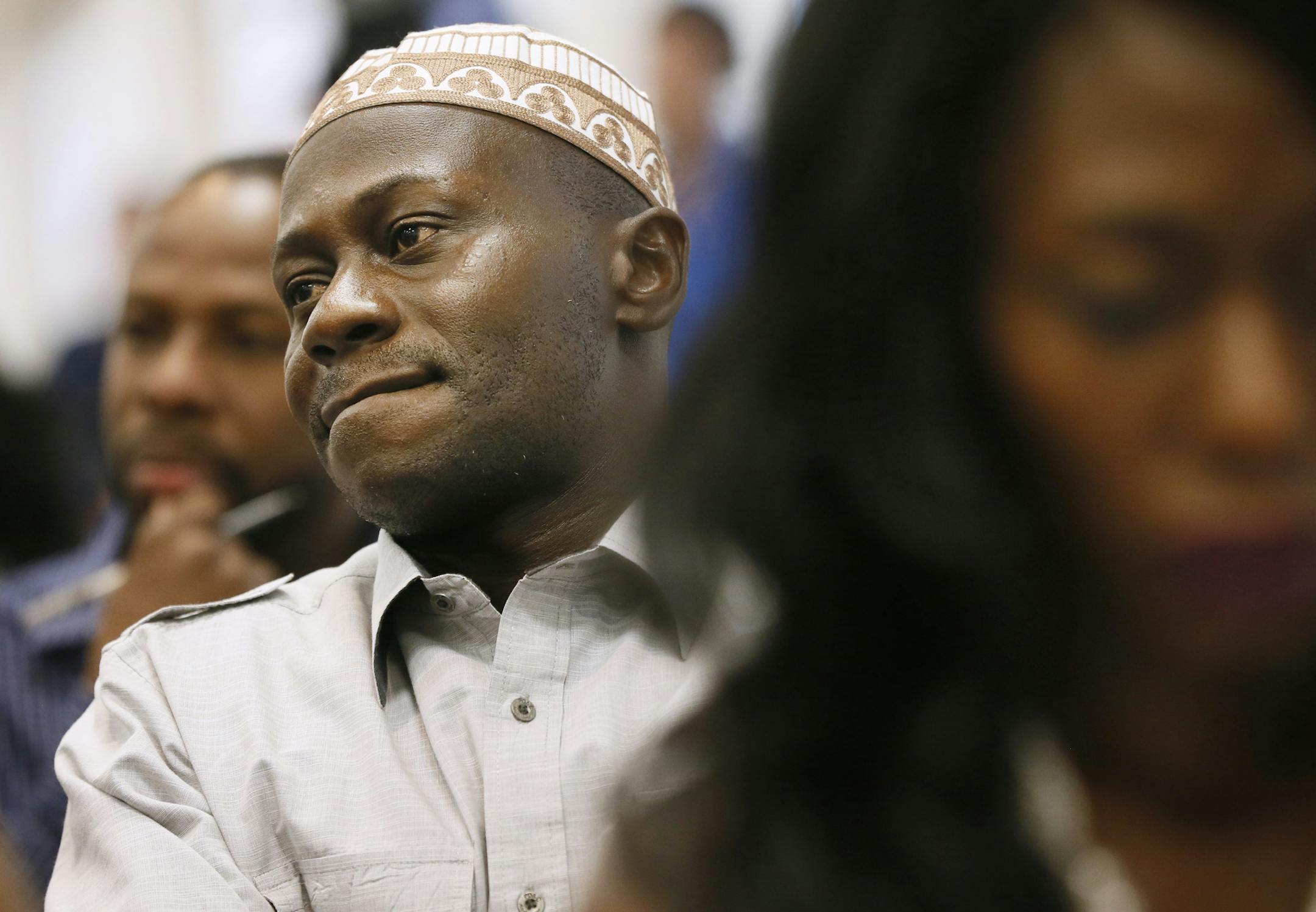 Isaac Owens left from Ghana, Abdullah Kiatamba, and Zoyea Queeglay-Weah both from Liberia now living in Brooklyn Park listened to a panel discussion about ebola. A community meeting was held to address the ebola virus in Liberia and two other West African countries Sunday August 3 , 2014 in Brooklyn Park , MN . ] Jerry Holt Jerry.holt@startribune.com
