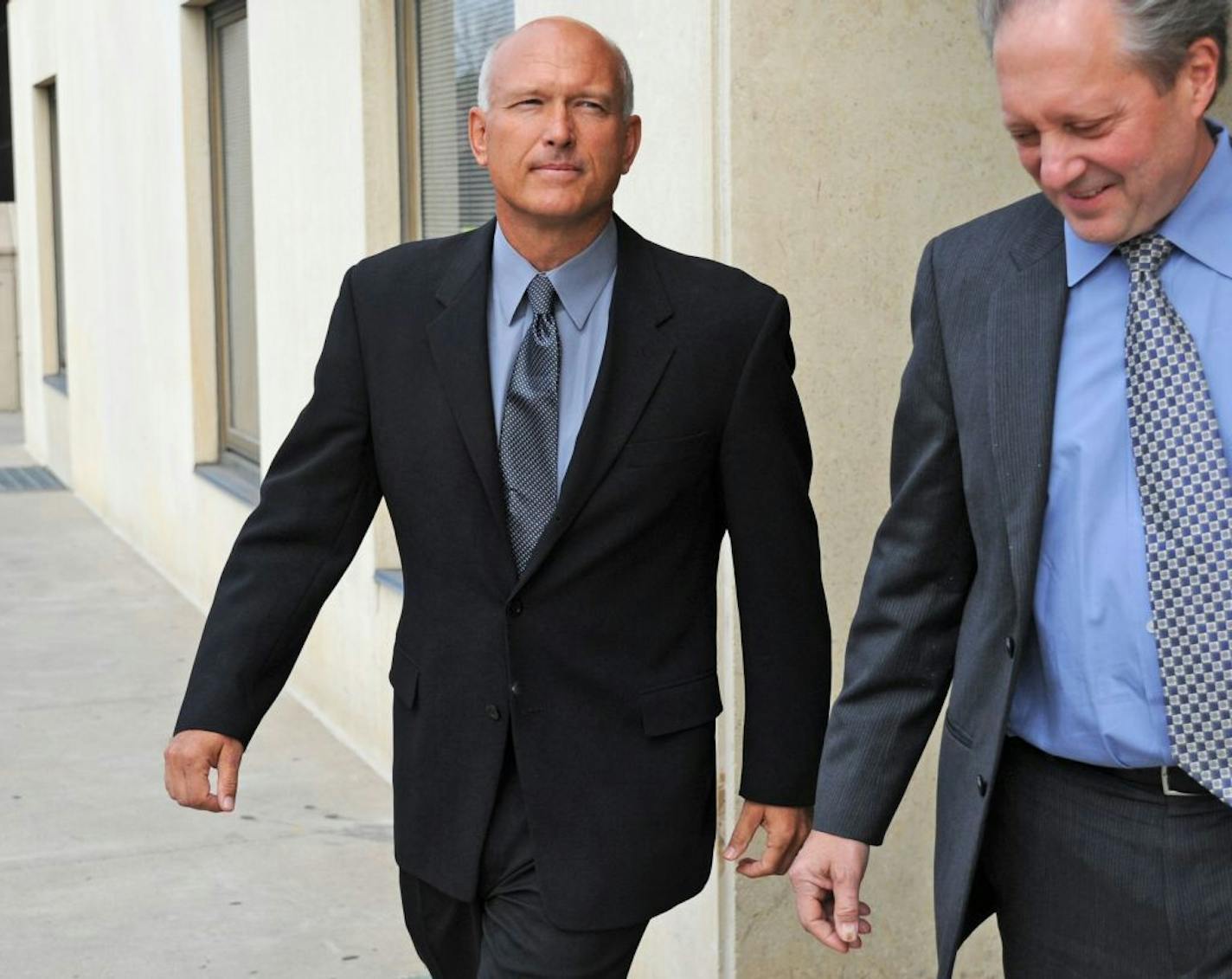 SWAT team leader David Clifford, charged with assaulting Brian Vander Lee at an Andover bar, appeared in Anoka County courthouse ,Thursday afternoon October 4, 2012. David Clifford left the courthouse with his attorney Fred Bruno on the right, after a brief appearance.