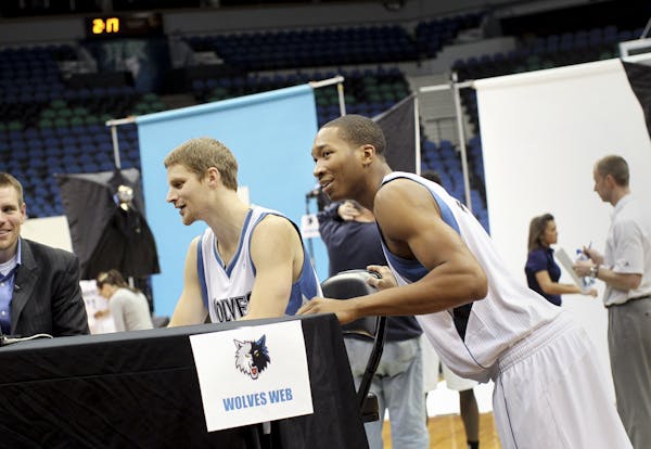 Wesley Johnson (4), right, sneaks into an interview with Luke Ridnour (13) during the Timberwolves media day at Target Center December 9, 2011.