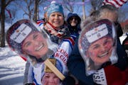 Deb Diggins held and wore photos of her daughter Jessie at the cross-country World Cup at Theodore Wirth Park on Saturday.