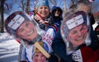 Deb Diggins held and wore photos of her daughter Jessie at the cross-country World Cup at Theodore Wirth Park on Saturday.