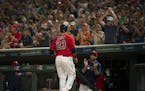 Minnesota Twins manager Rocco Baldelli and the crowd applauded Minnesota Twins designated hitter Nelson Cruz (23) after he scored on a Eddie Rosario s