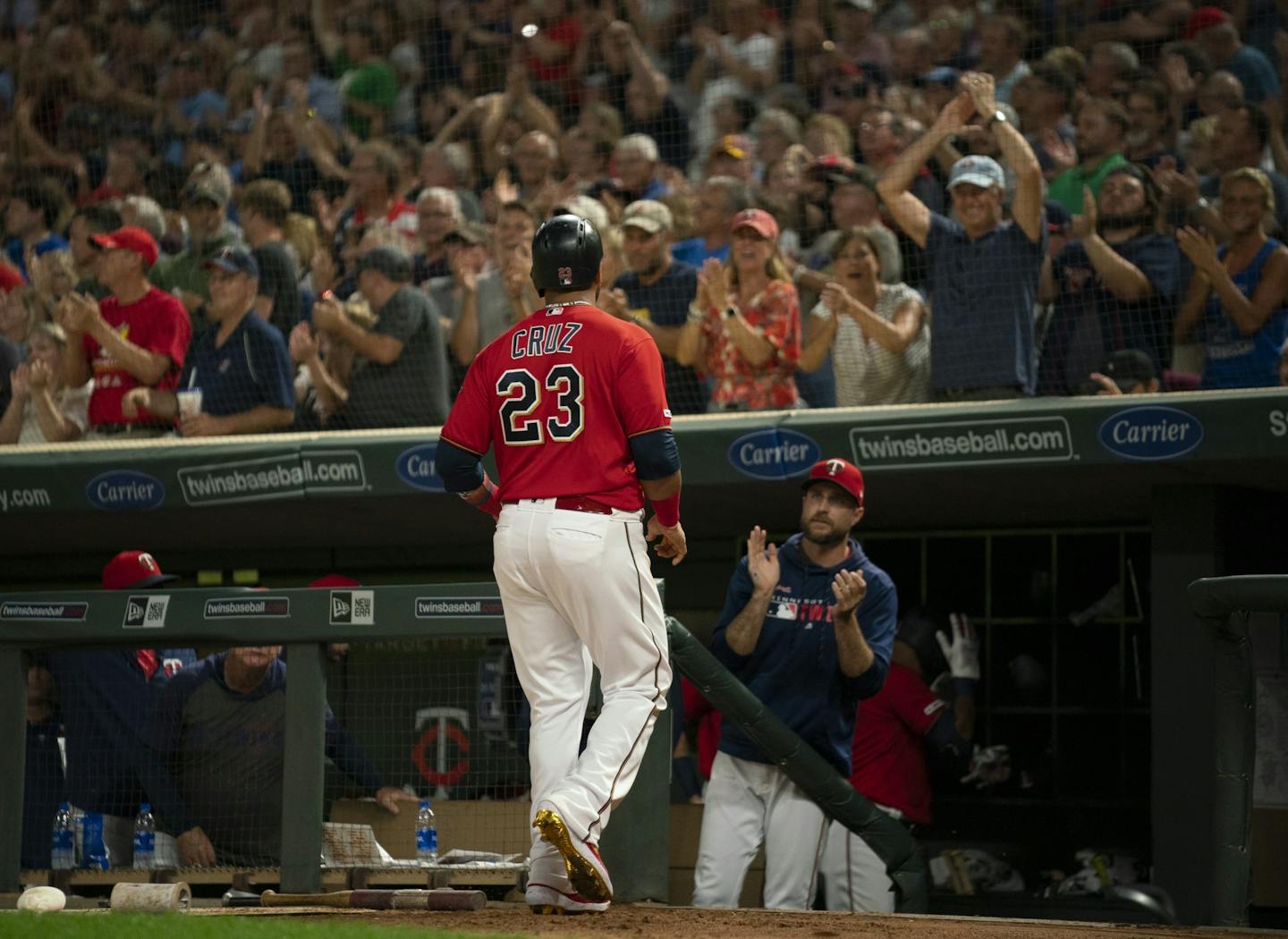 Minnesota Twins manager Rocco Baldelli and the crowd applauded Minnesota Twins designated hitter Nelson Cruz (23) after he scored on a Eddie Rosario single after his own two RBI double in the fifth inning.