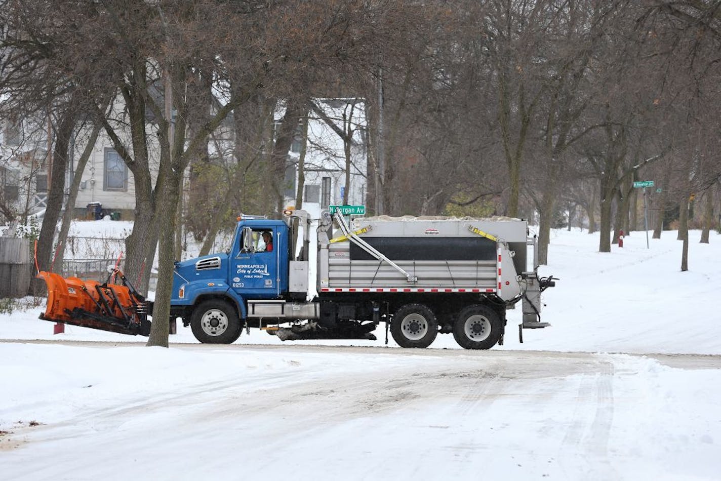 City of Minneapolis truck driver Vicky Stich plows snow and lays down sand and salt on Olson Highway Service Road in Minneapolis on Tuesday, November 11, 2014. Stich has been driving a truck for the city for 38 years.