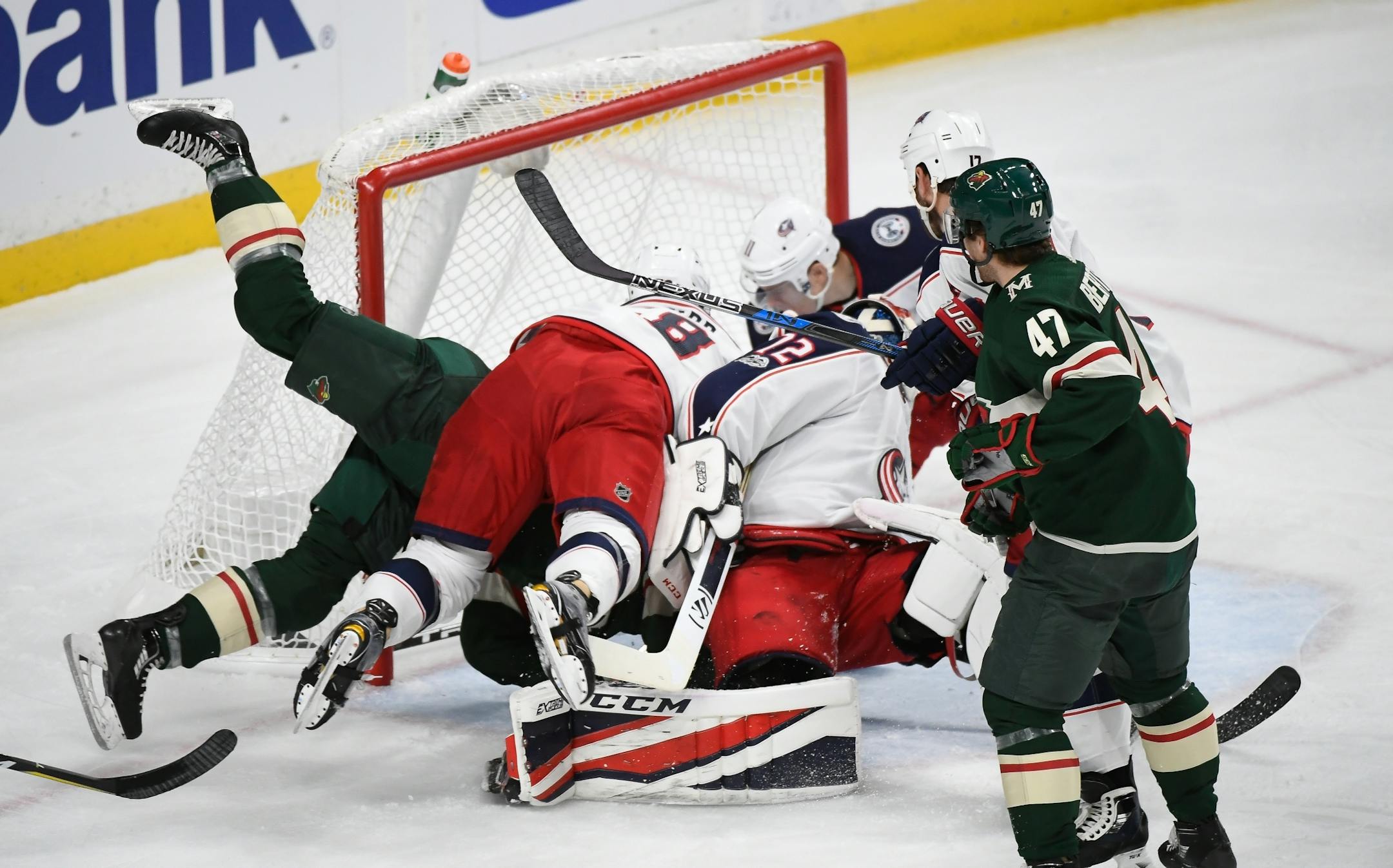 Players piled up as Minnesota Wild center Landon Ferraro (41) scored a goal in the second period against the Columbus Blue Jackets.