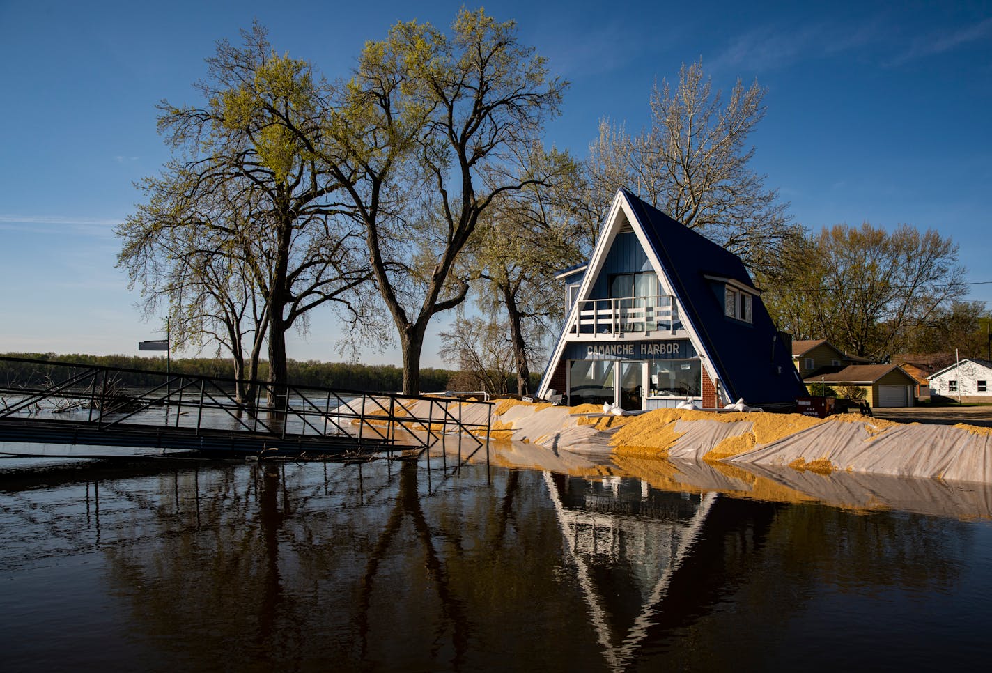 Rising Mississippi River waters approach a sand barrier at the marina in Camanche, Iowa on April 26. Credit: Nick Rohlman, The Gazette