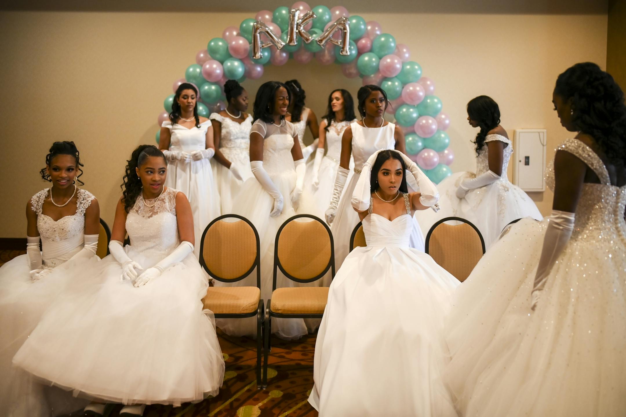 Debutantes prepared to have their group photo taken a few hours before the start of Saturday's winter cotillion.