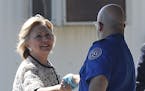 Democratic presidential candidate Hillary Clinton greets people as she arrives at Provincetown Municipal Airport in Provincetown, Mass., Sunday, Aug. 