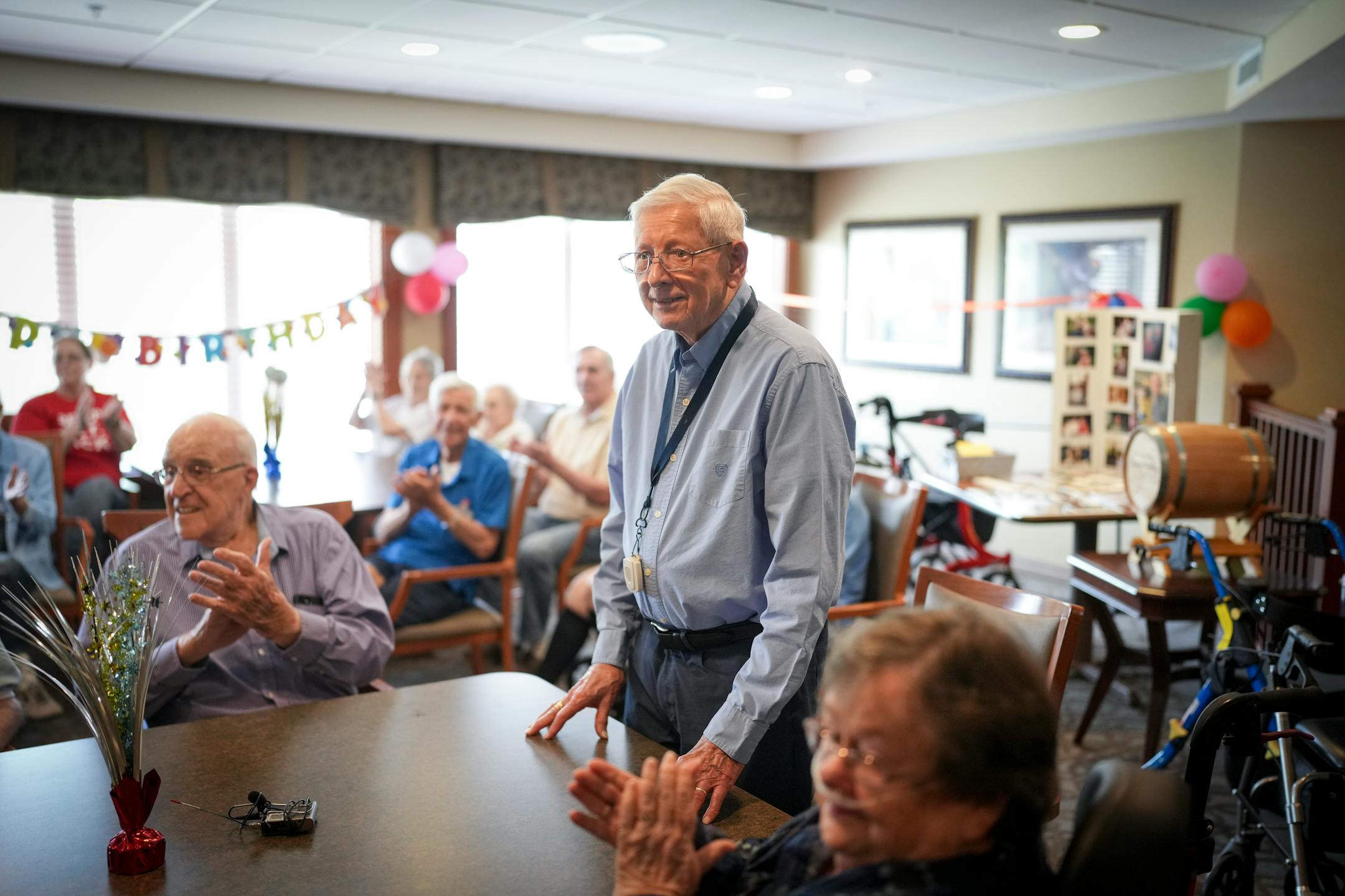 Richard King is applauded as he celebrates turning 100 with fellow residents and staff at his home New Perspective Woodbury senior facility in Woodbury, Minn., on Thursday, June 8, 2023.