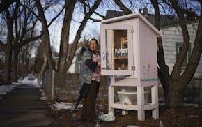 After she got home from work, Jamie Hendricks restocked the shelves of the Little Free Pantry she maintains in front of her home in St. Paul's North E