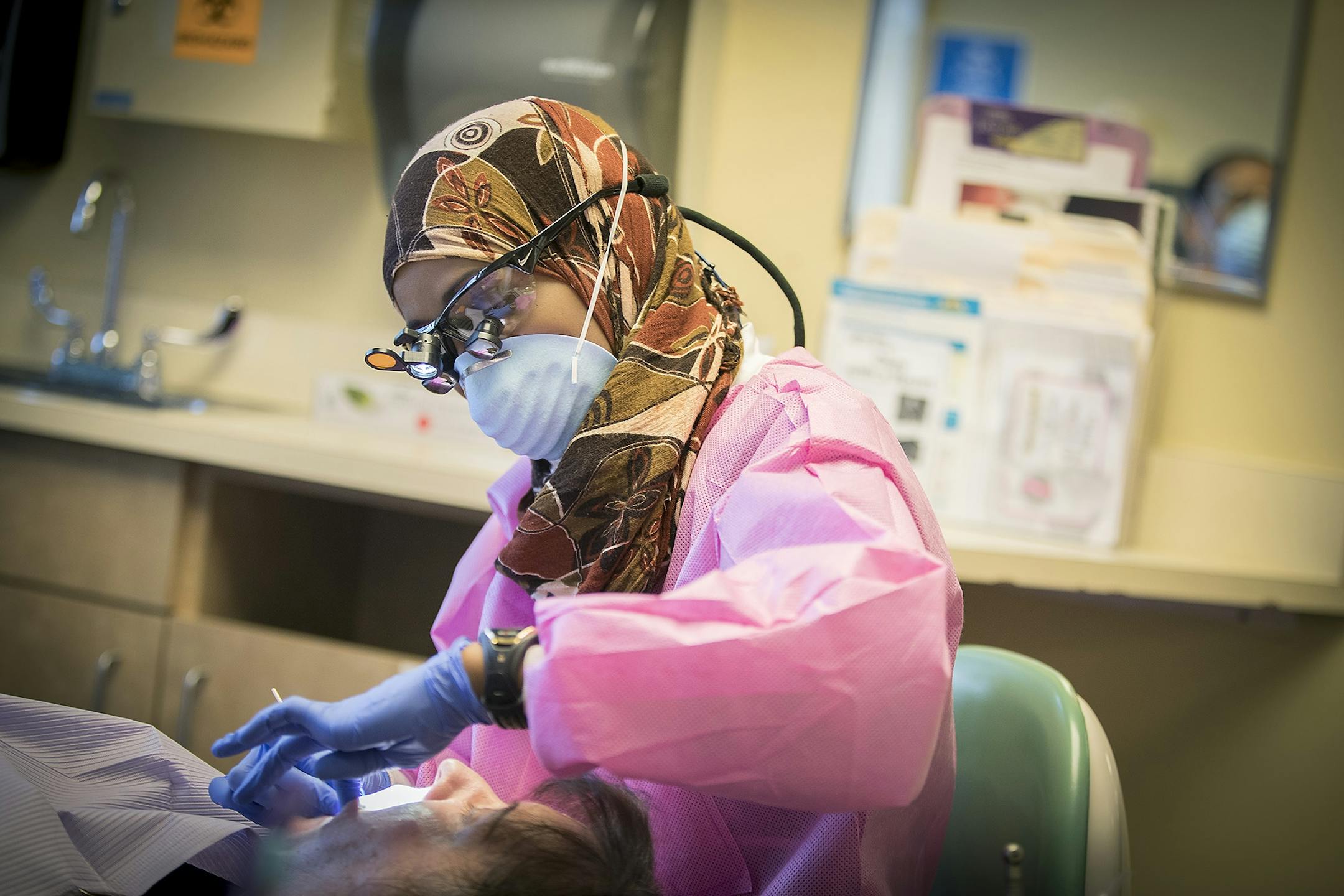 Dentist Dr. Sagal Nur, right, worked on a patient with dental assistant Rita Robinson at Open Cities Health Center, Thursday, July 27, 2017 in St. Paul, MN.