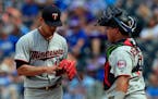 Twins starting pitcher Jose Berrios, left, shows his blistered finger to catcher Willians Astudillo during the eighth inning