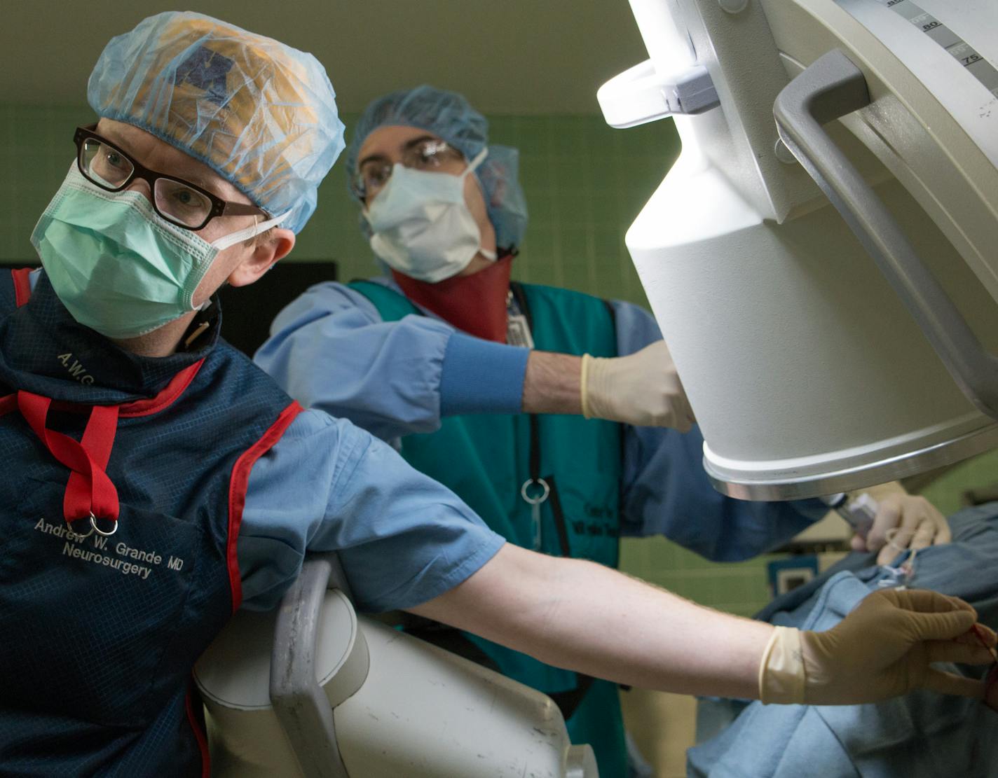 1267: Dr. Andrew Grande, an assistant professor of neurosurgery at the University of Minnesota, helps chief resident Dino Terzic threat a stylette through a patient&#x201a;&#xc4;&#xf4;s cheek into the base of the skull. Once it&#x201a;&#xc4;&#xf4;s placed, Terzic will inflate a balloon at the tip of the device, crushing the trigeminal nerve to treat a condition that&#x201a;&#xc4;&#xf4;s so painful it&#x201a;&#xc4;&#xf4;s nicknamed &#x201a;&#xc4;&#xfa;the suicide disease.&#x201a;&#xc4;&#xf9; Phot