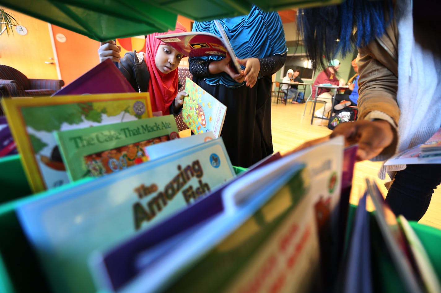 Salma Fiqi 5 looked for a book to read during a tutoring session at Hope Community. The kids got help with reading from volunteer students at the University of Minnesota a Saturday November 7, 2015 in Minneapolis, MN. ] During neighborhood listening sessions, Hope Communities learned that parents wanted a place where their children could learn and grow. So it created "Learning Communities&#xed;&#xed;. Jerry Holt/ Jerry.Holt@Startribune.com