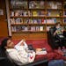 Sixth-graders Isaac Firkus, left, and James Dalbacka-Hoogenboom relax and read books in the school library at Franklin STEAM Middle School in Minneapo