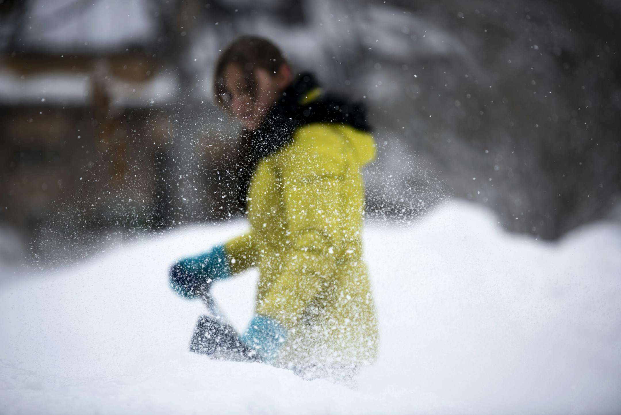 Natasha Cramer, of Robbinsdale, shoveled snow in her driveway after returning home from work Wednesday.