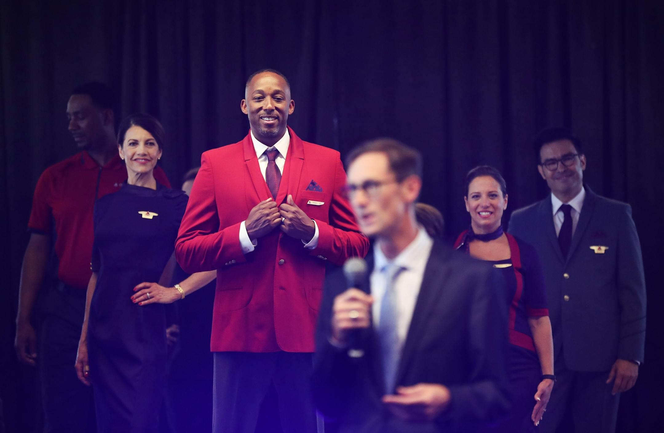 Delta Air Lines launched its new line of uniforms for all its employees during a fashion show at MSP with designer Zac Posen & manufacturer Lands End showcasing the new look Tuesday, May, 29, 2018, at Terminal 1 between Gates G1-G3 at the Minneapolis-St. Paul International Airport in Bloomington, MN. Here, Delta employees in the fashion show listen as Gareth Joyce, Delta Senior Vice President-Airport Customer Service and President Cargo, addressed those gathered at the fashion show.