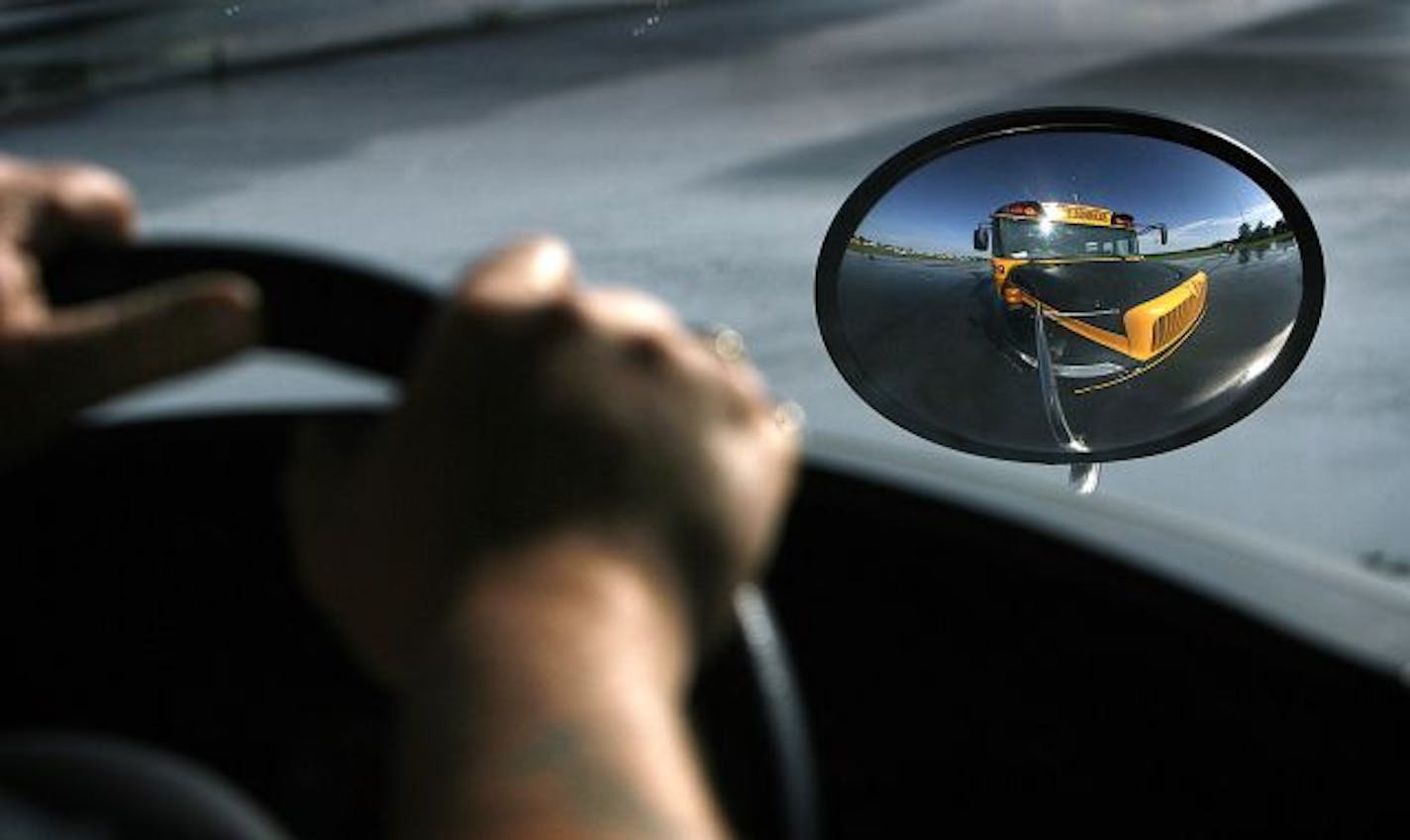 JIM GEHRZ � jgehrz@startribune.com
Rosemount/August 28, 2009/9:00 AM
The hands of Minneapolis Public Schools bus driver and trainer Mike Isenhower clutched the steering wheel as he drove a course at the Dakota County Technical College in Rosemount. Isenhower and other drivers for MPS are going through or have completed a professional school bus driver academy this summer to learn how to better deal with behavior management, emergencies and other skills required by the job. Riding with Isenhower