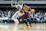 Gophers guard Cam Christie, right, looks to keep the ball away from Butler in the first round of the NIT on Tuesday at Hinkle Fieldhouse in Indianapol