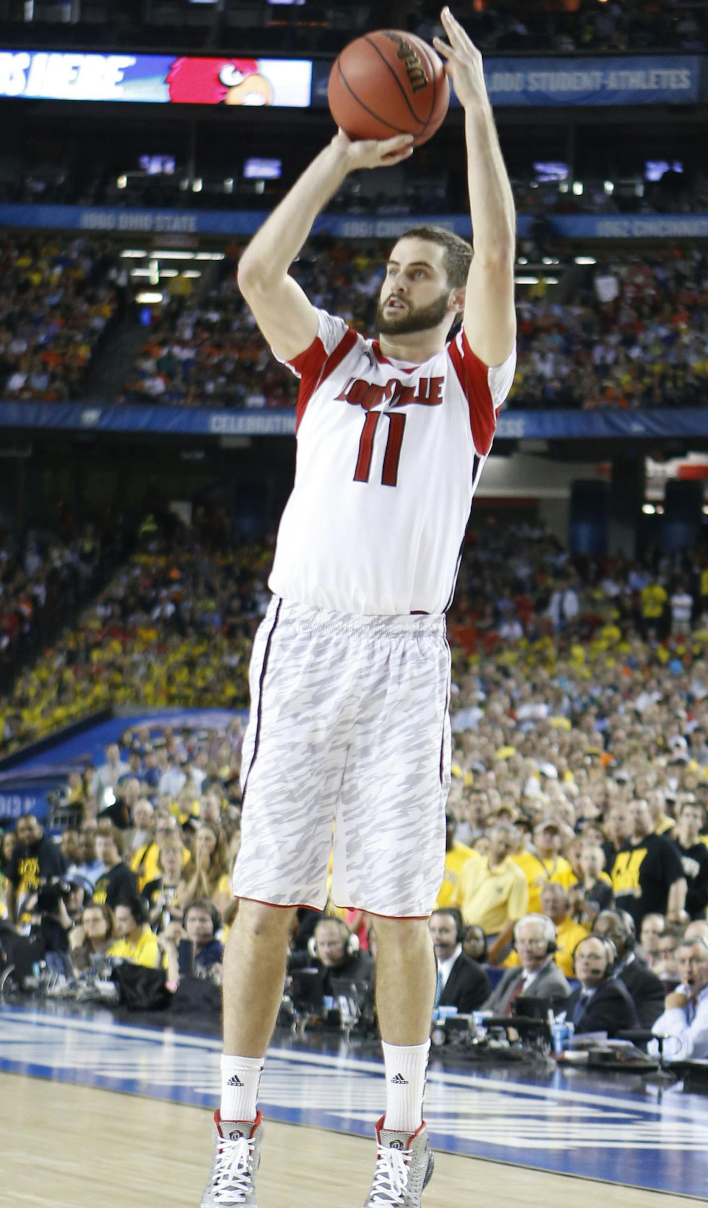 Louisville guard Luke Hancock (11) put up a three-point shot against Wichita State late in the second half of a semi-final matchup in the NCAA Men's Basketball Championship at the Georgia Dome in Atlanta, Georgia, Saturday, April 6, 2013. Louisville defeated Wichita State, 72-68. (Mark Cornelison/Lexington Herald-Leader/MCT) ORG XMIT: 1137190