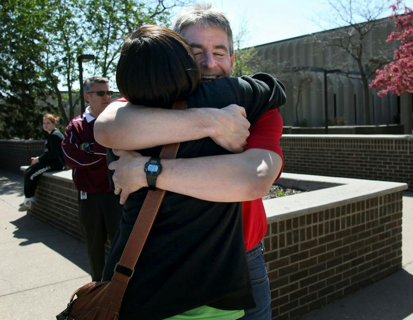 Anoka High School math teacher Paul Kelley gave Caitlin Eisel, a student teach, a hug as they both supported "A Day of Silence" moment at Anoka High School, Friday, April 20, 2012. GLBT students and their allies kept their quiet to protest the silencing effect of anti-LGBT bullying and harassment in schools. After last month's landmark legal settlement in Anoka Hennepin, teachers were wearing T-shirts in solidarity with participating students. The policy that was reversed before the settlement w