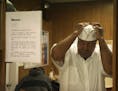 Othea Loggan, a busboy at Walker Bros Pancake House, where he has worked for 54 years, adjusts a fresh, clean white paper hat for in a back room at Wa