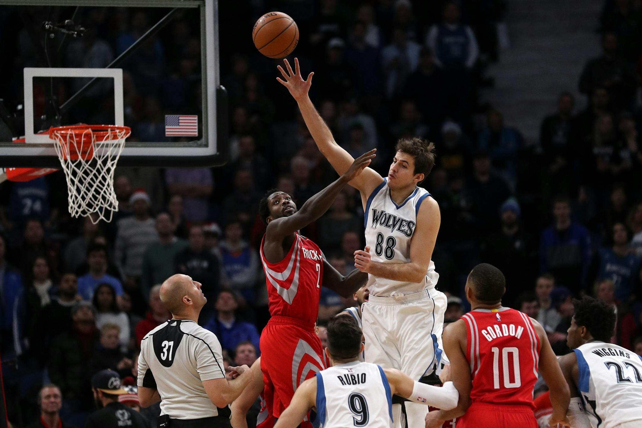 Minnesota Timberwolves forward Nemanja Bjelica (88) passes the ball over the head of Houston Rockets guard Patrick Beverley (2) in overtime.