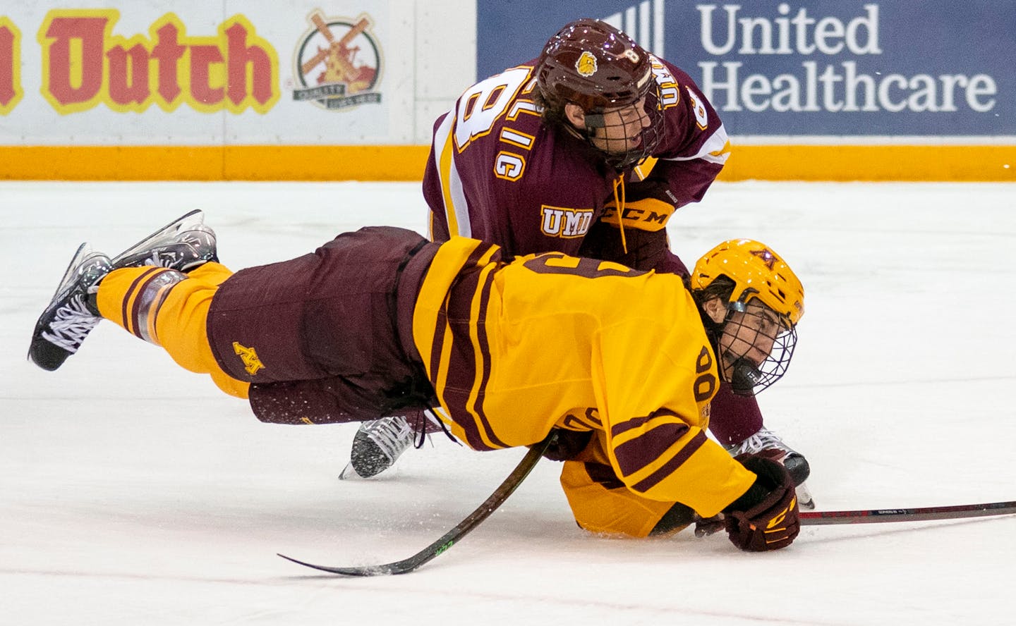 Gophers forward Matthew Knies falls over the stick of Minnesota Duluth defenseman Hunter Lellig in the series opener Friday night.