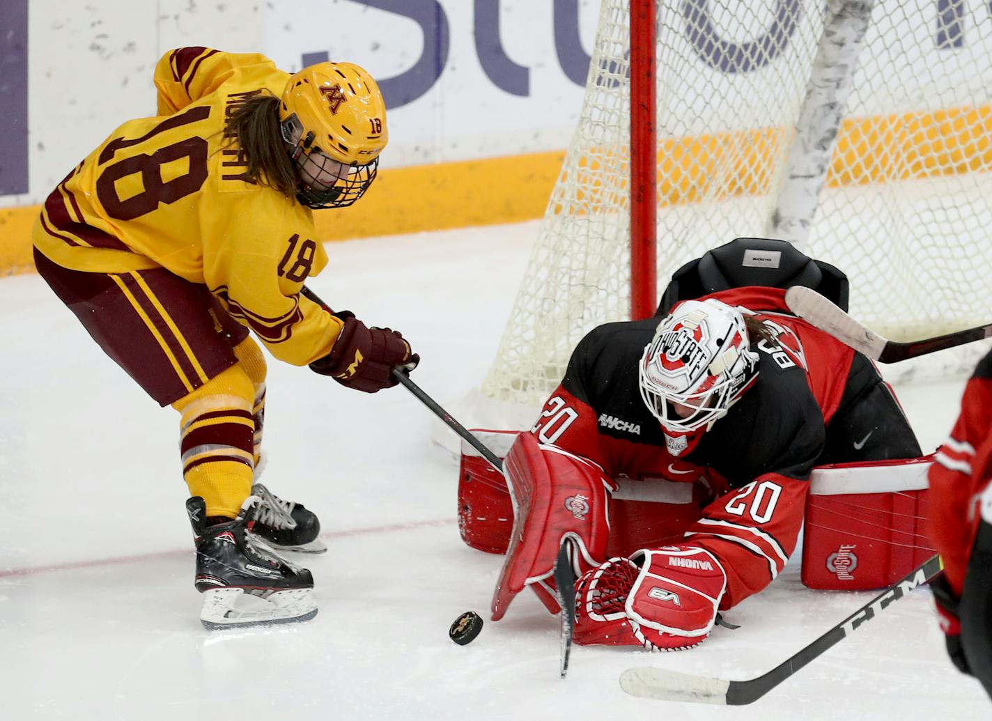 The University of Minnesota Gopher's Abbey Murphy (18) can't get the puck past Ohio State goalie Andrea Braendli (20) during the third period in Minneapolis. The Buckeyes beat the Gophers 2-1. ]