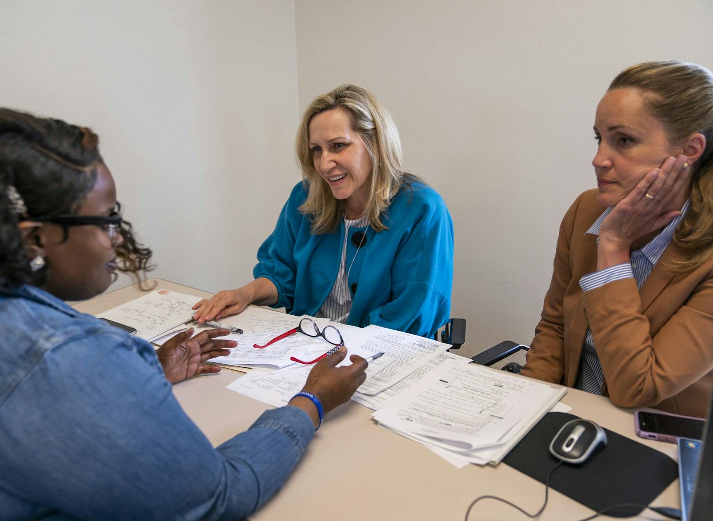 Antwanesha Amos, from left, meets with Mary Stanley and Elizabeth Kremenak, both attorneys with Target Corp, during an eviction expungement legal clinic. ] LEILA NAVIDI &#xa5; leila.navidi@startribune.com BACKGROUND INFORMATION: Attorneys meet with clients during a pro bono legal clinic for eviction expungement at North Regional Library in Minneapolis on Tuesday, April 9, 2019.