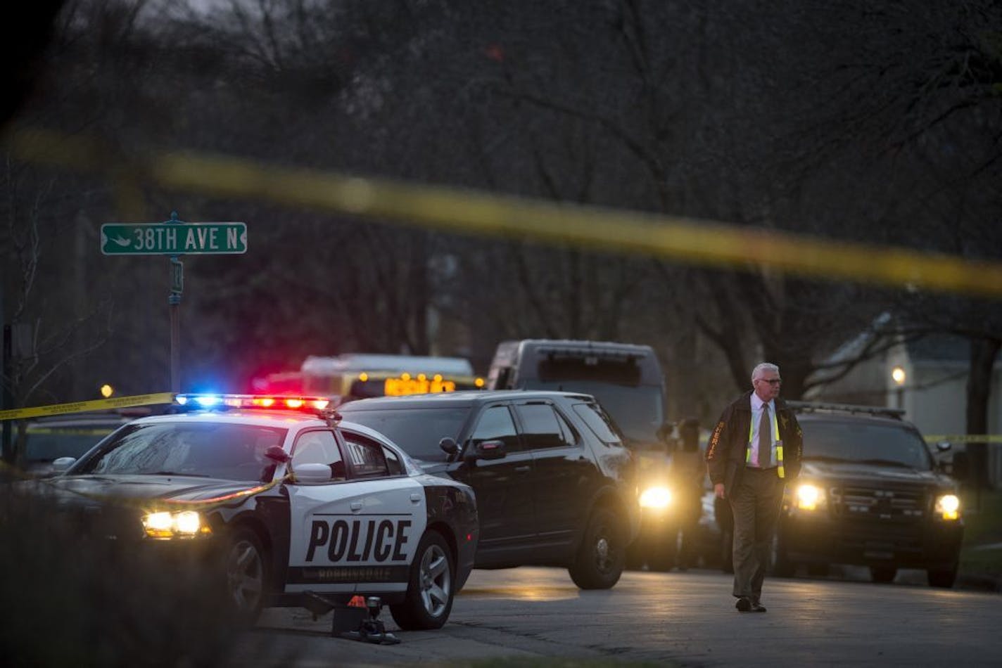 An investigator walks the scene of an officer involved shooting at 38th Avenue North and Hubbard Avenue North in Robinsdale on Thursday, April 16, 2015.