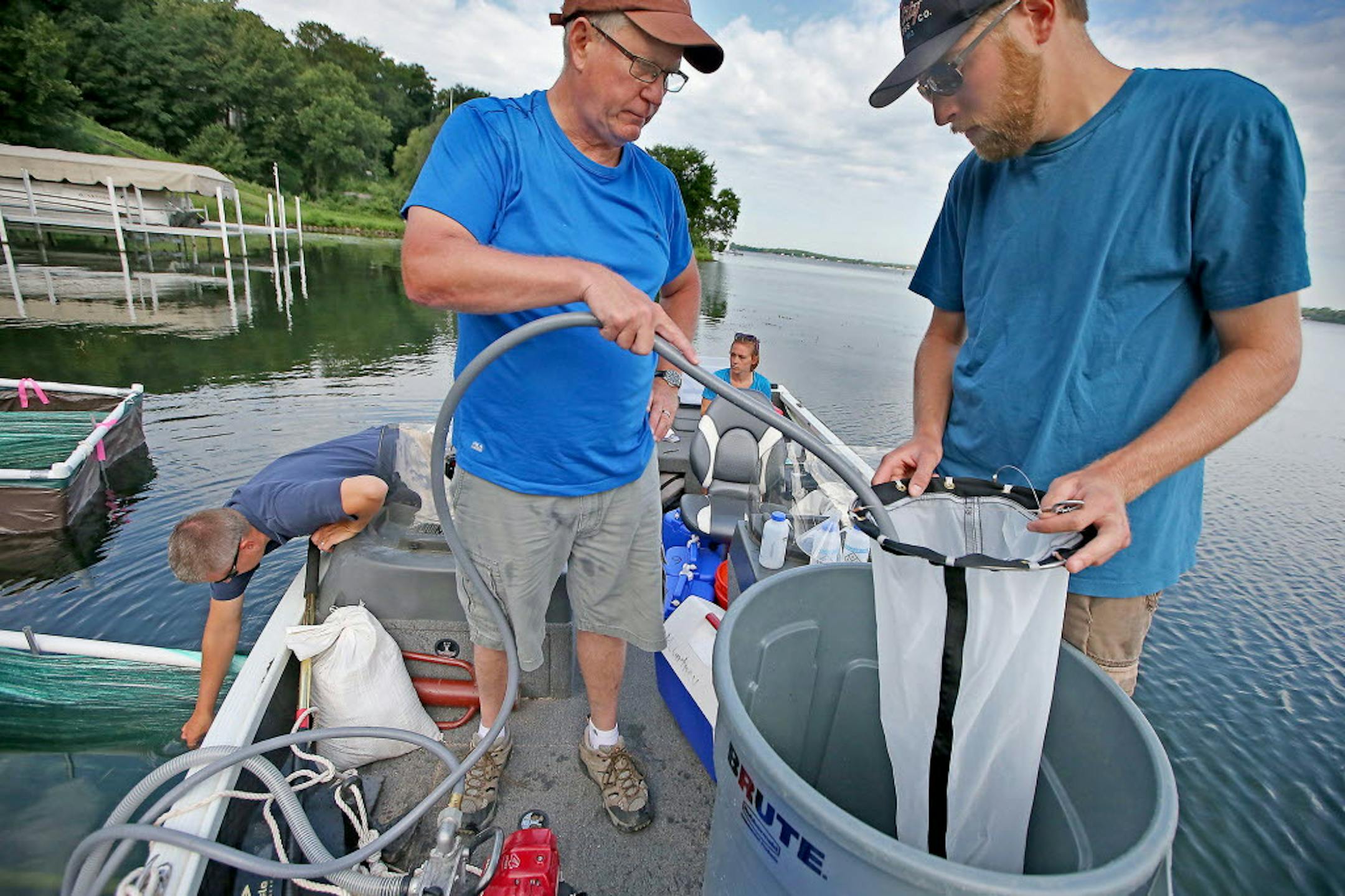 Minnehaha Creek Watershed District AIS Program Manager Eric Fieldseth, far left, University of Minnesota AIS Research Center's Dr. Michael McCartney, center, and Max Kleinhans, tested a project targeting tiny zebra mussels with low doses of a copper-based pesticide in Robinson Bay on Lake Minnetonka in July 20, 2016. Now the product is being used on Lake Minnewashta in September 2016.