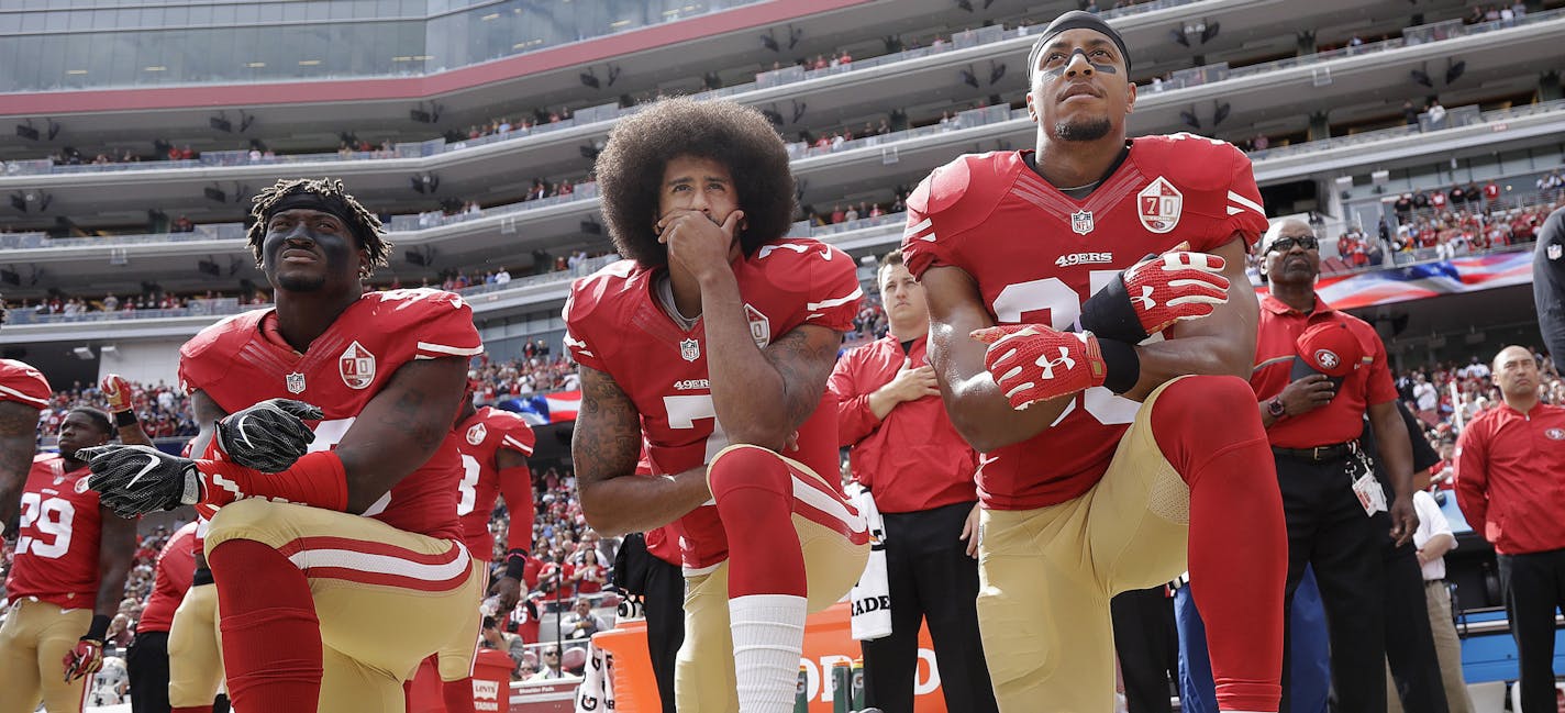 FILE - In this Oct. 2, 2016 file photo, from left, San Francisco 49ers outside linebacker Eli Harold, quarterback Colin Kaepernick and safety Eric Reid kneel during the national anthem before an NFL football game against the Dallas Cowboys in Santa Clara, Calif. In recent months, Colin Kaepernick has become comfortable with people knowing him as more than a laser-focused football player as he always previously preferred it. Perhaps, through the anthem protest and his emergence as an outspoken ac