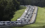 A car rides in the shoulder to pass other cars in evacuation traffic on I-75 N, near Brooksville, Fla., in advance of Hurricane Irma, Saturday, Sept, 