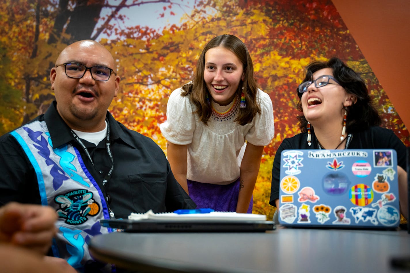 Taylor Fairbanks (middle), one of the Native American Undergraduate Museum Fellows (NAUMF) and August Mentch (right), the program support intern, laugh with other attendees before the culminating presentations for the program at the Minnesota Historical Center in St. Paul, Minn. on Friday, Aug. 11, 2023. The six fellows from this summer now join 92 other alumni of the program, which is aimed to introduce undergraduates with Native heritage to experiences that connect with their families and culture in ways they may not otherwise have. ] Angelina Katsanis • angelina.katsanis@startribune.com