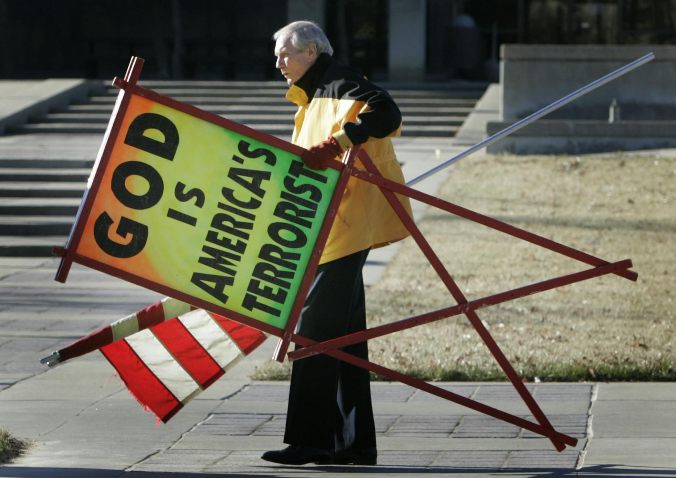 FILE - In this July 1, 2007 file phtoo, the Rev. Fred Phelps Sr. prepares to protest outside the Kansas Statehouse in Topeka, Kan. Phelps, the founder of the Kansas church known for anti-gay protests and pickets at military funerals, died Thursday, March 20, 2014. He was 84. (AP Photo/Orlin Wagner, File)
