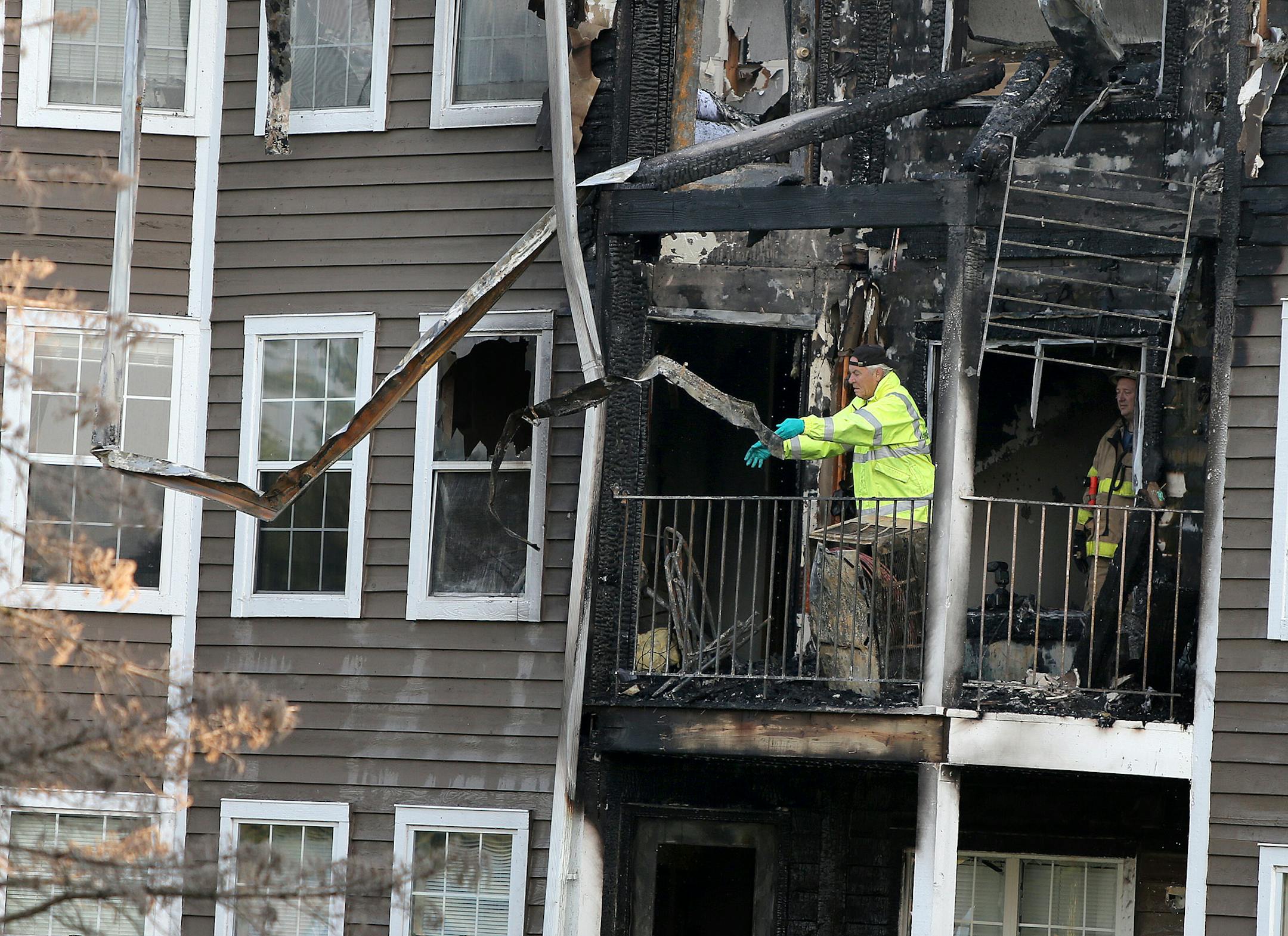 Plymouth firefighters worked the aftermath of an early morning fire at Vicksburg Village Apartments, Friday, July 12, 2013 in Plymouth, MN. (ELIZABETH FLORES/STAR TRIBUNE) ELIZABETH FLORES � eflores@startribune.com