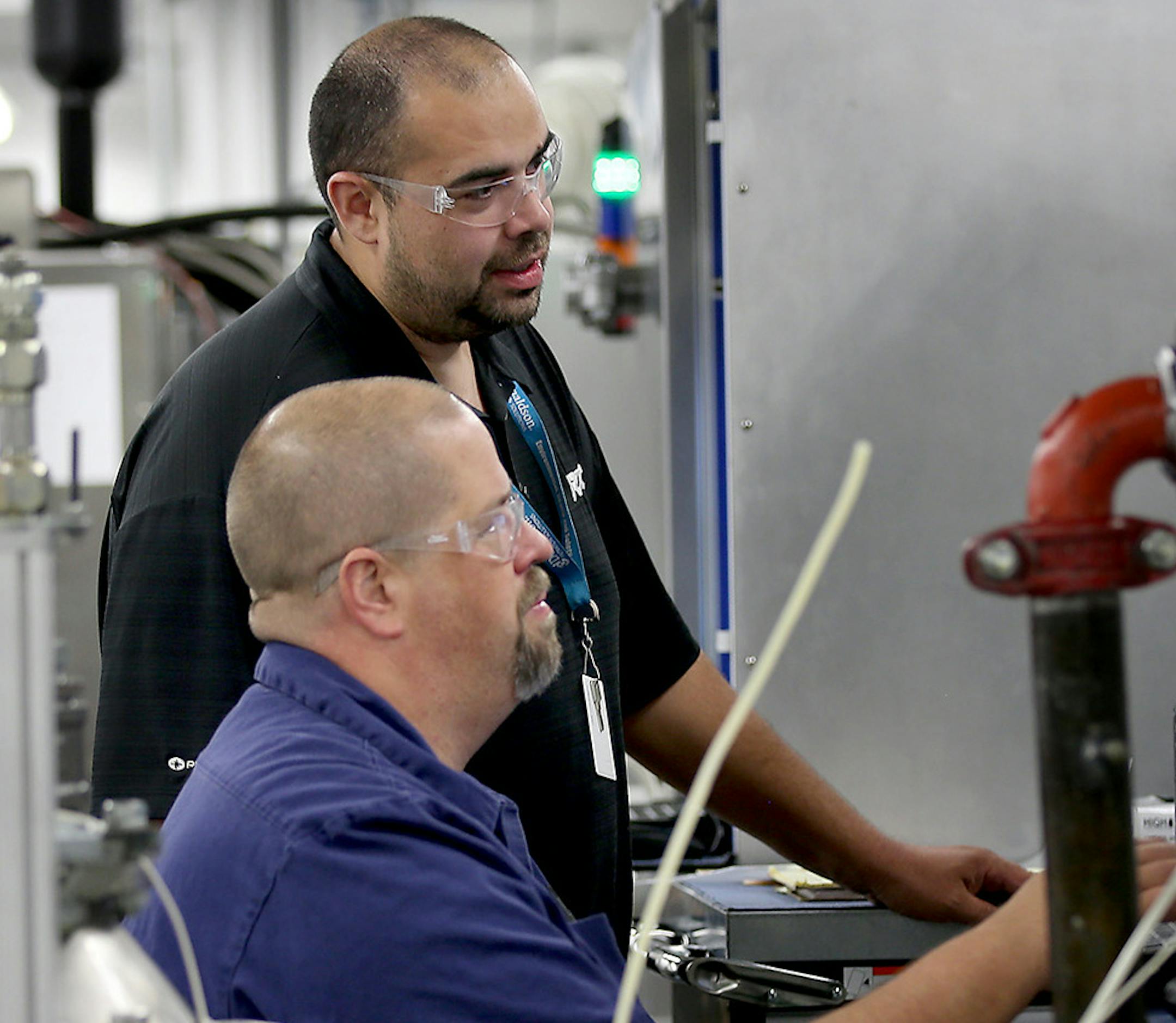 Employees of Bloomington-based Donaldson Company, which implemented a shares buyback program of its own last year, tested out a product.