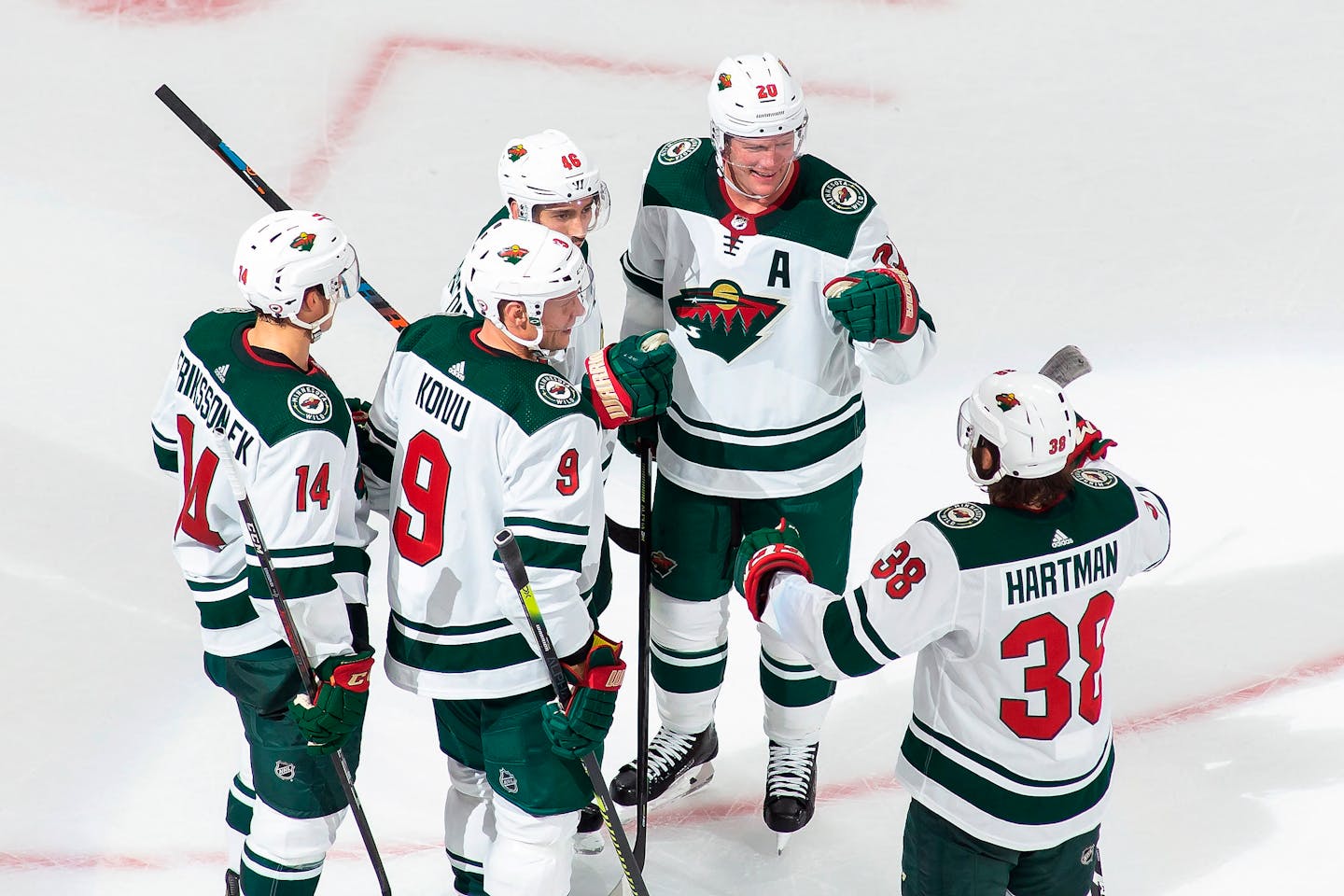 The Wild's Joel Eriksson Ek (14), Mikko Koivu (9), Jared Spurgeon (46), Ryan Suter (20) and Ryan Hartman (38) celebrate Spurgeon's goal against the Canucks on Aug. 2.