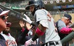 Detroit Tigers' Nicholas Castellanos is greeted in the dugout after his two-run homer off Minnesota Twins pitcher Martin Perez in the first inning of 