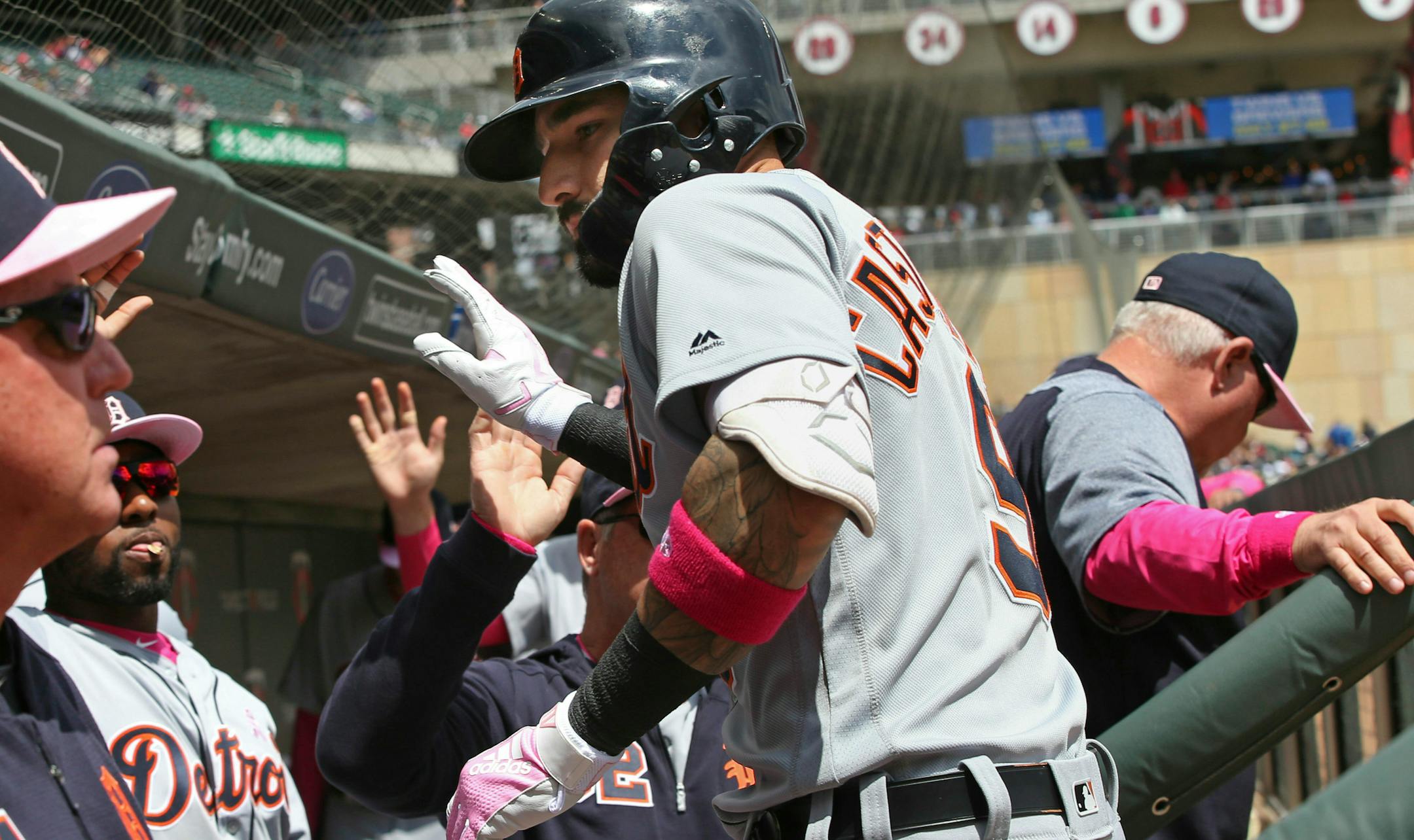 Detroit Tigers' Nicholas Castellanos is greeted in the dugout after his two-run homer off Minnesota Twins pitcher Martin Perez in the first inning of a baseball game Sunday, May 12, 2019, in Minneapolis. (AP Photo/Jim Mone)