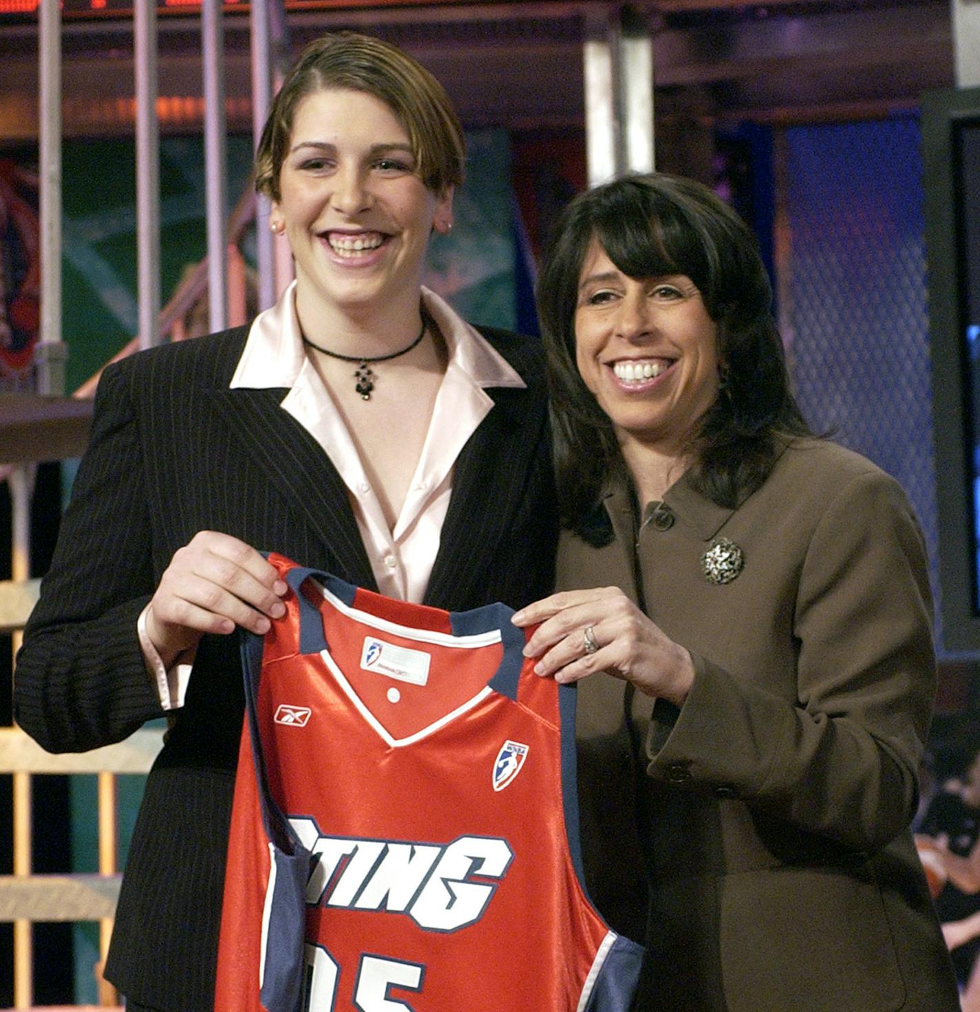 Minnesota's Janel McCarville, left, holds up a Charlotte Sting jersey with WNBA President Donna Orender after being selected as the No. 1 overall pick the WNBA Daft Saturday, April 16, 2005, in Secaucus, N.J. (AP Photo/Bill Kostroun) ORG XMIT: MIN2013051715434992