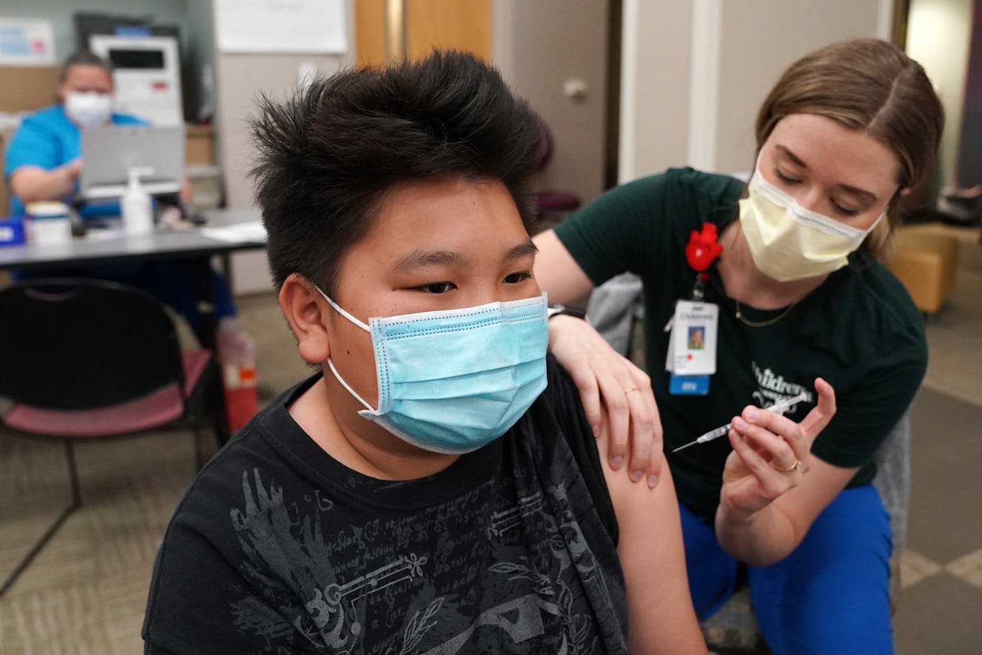 Kuabcag Yang, 13, of Brooklyn Park, Minn. got his first dose of the Pfizer COVID-19 vaccine from nurse Jenn Doble Thursday at Children's Minnesota. ] ANTHONY SOUFFLE • anthony.souffle@startribune.com