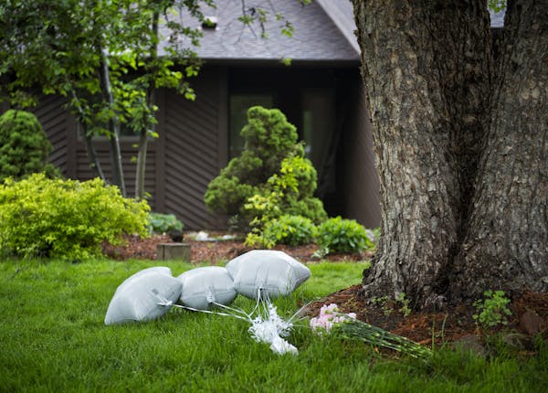 Flowers and balloons were left at the scene of Tuesdays shootings at 5977 Grotto St. N, Shoreview where two people were shot and killed. Wednesday, Ju