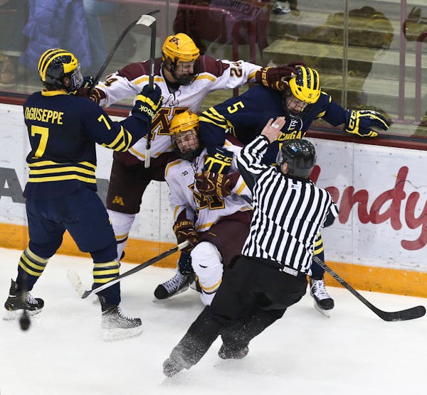 A fight broke out between Michigan's Phil Di Guiseppe (7), Michael Downing (5) and Minnesota's Hudson Fasching (24) and Kyle Rau (7) during the third 