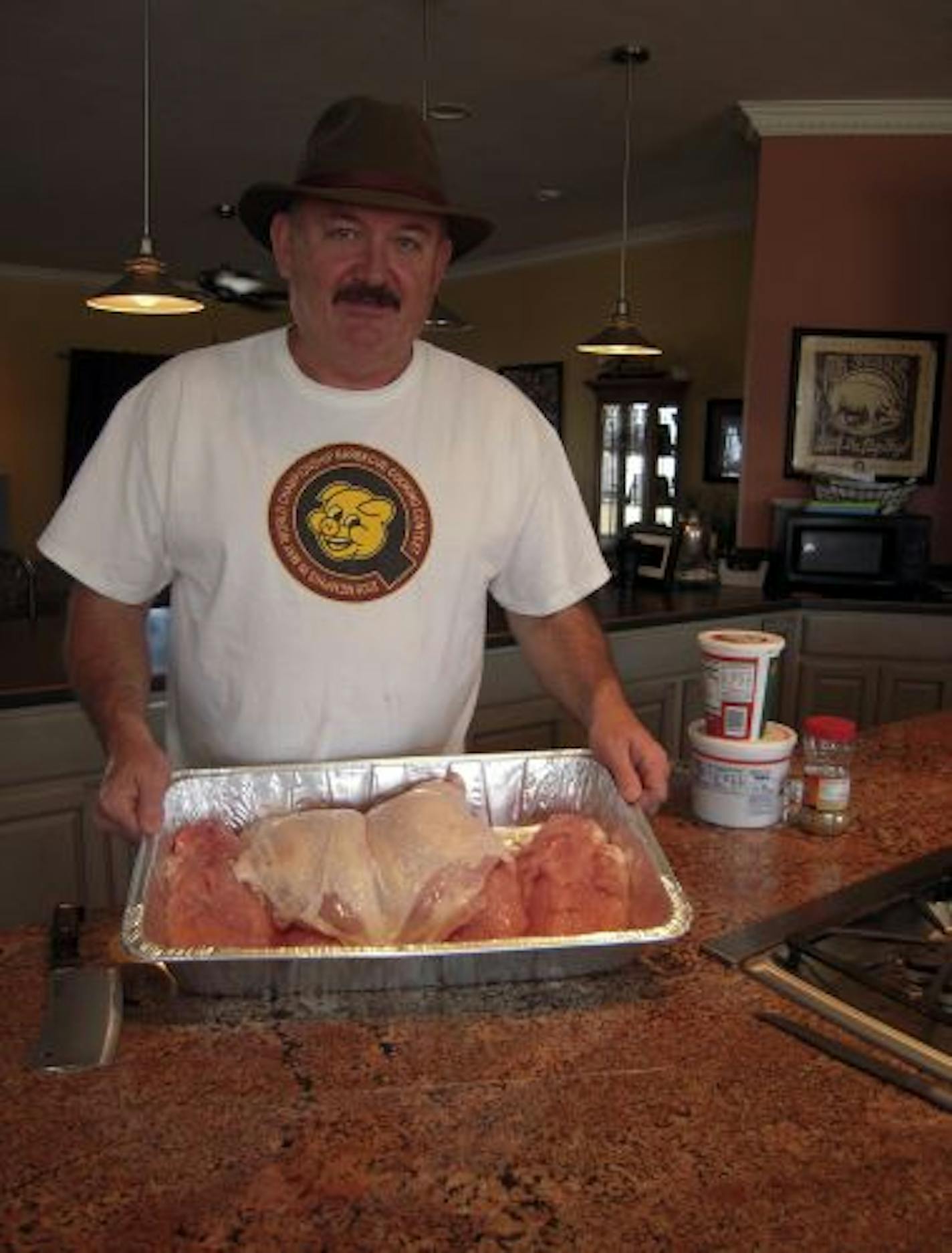 Mike Barnes prepped turkey breasts to go in the smoker at his home-based carryout business in New Madrid, Missouri.