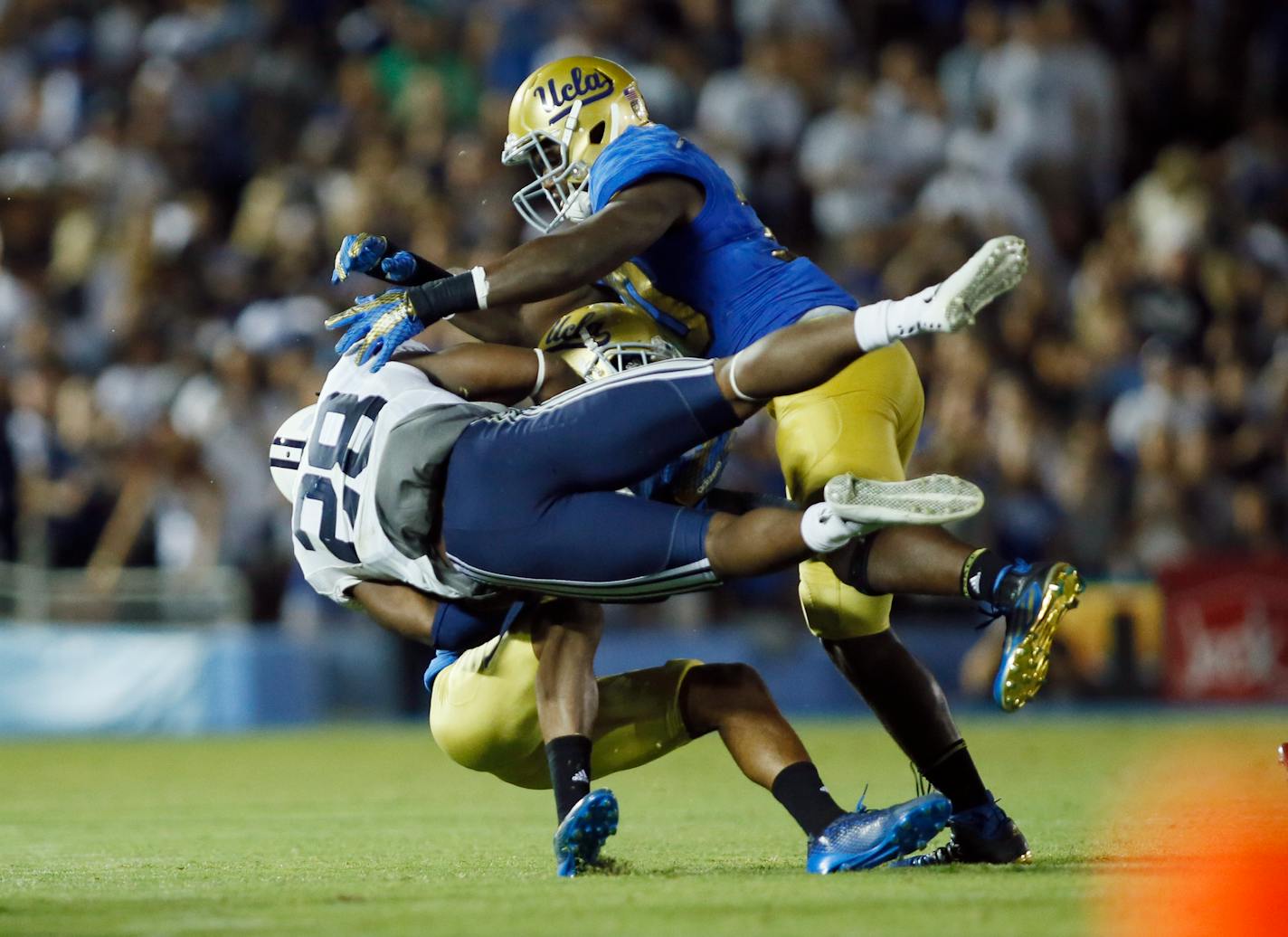 UCLA linebacker Myles Jack, top right, stops BYU running back Adam Hine during the second half of an NCAA college football game, Saturday, Sept. 19, 2015, in Pasadena, Calif. UCLA won 24-23. (AP Photo/Danny Moloshok)